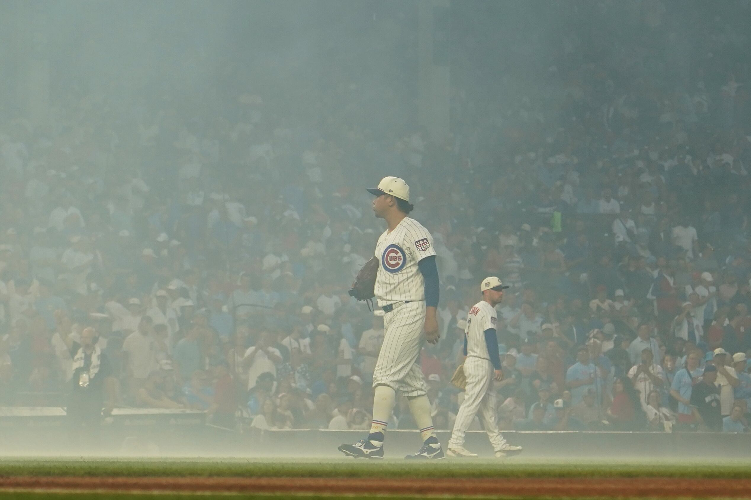 Cubs Fans Serenade Wrigley Field During Fog Delay, Singing 'Take Me Home, Country Roads'.