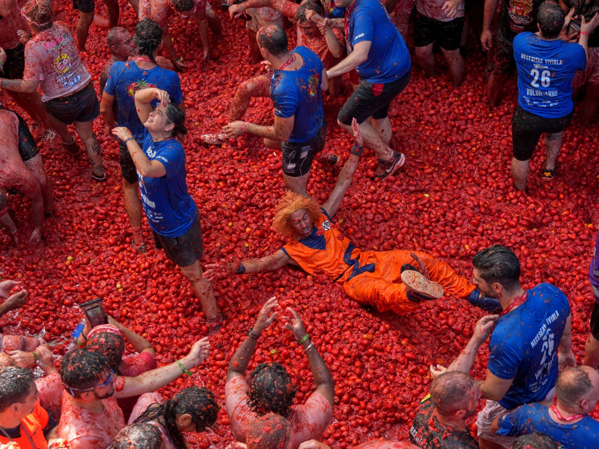 More than 20,000 participants gather in Spain to hurl 165 tons of tomatoes.