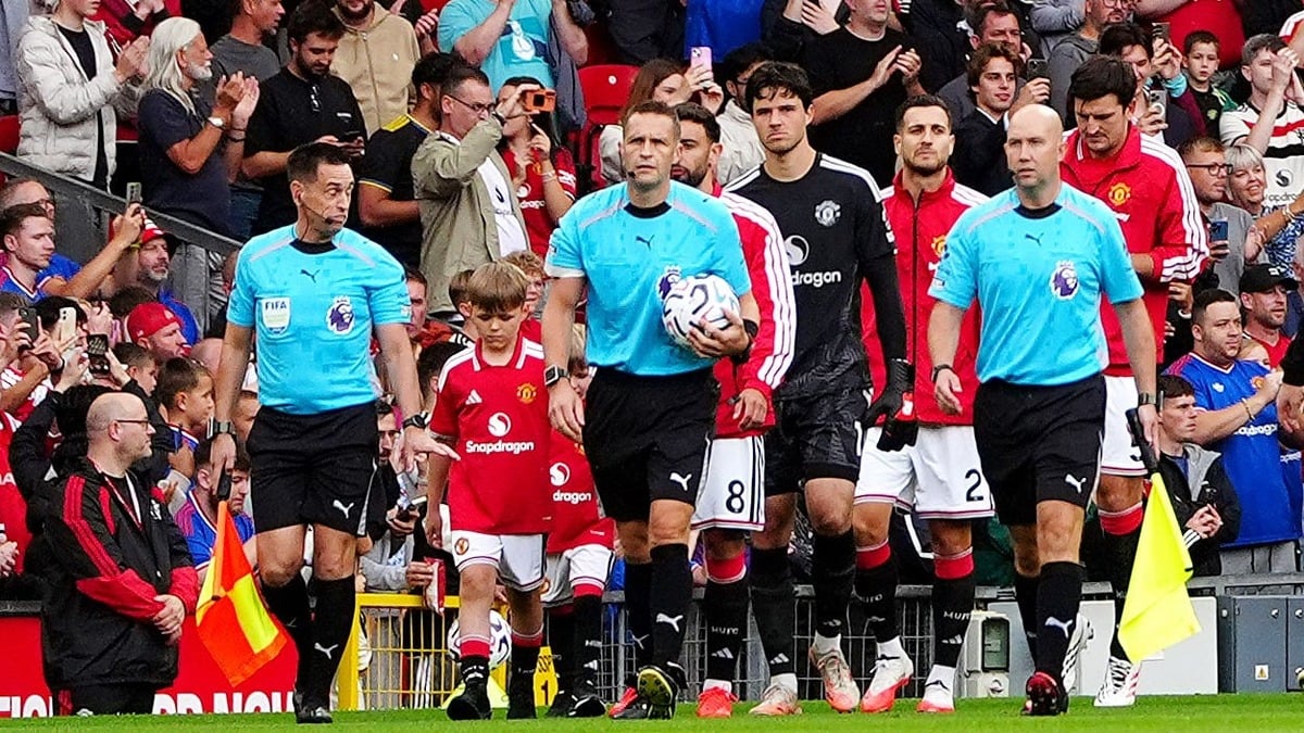 Sons of slain police officers lead Manchester United out in emotional football tribute.