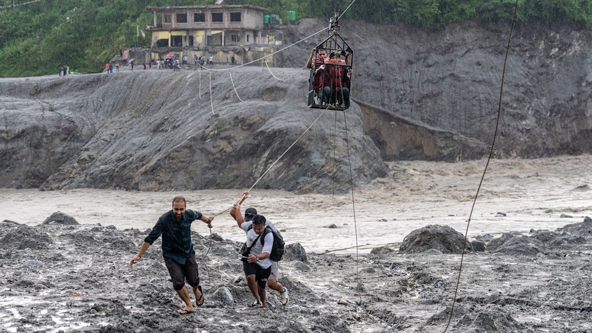 Nepal flood survivors cross swollen river by zip line amid ongoing disaster crisis