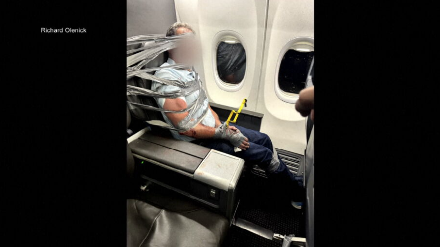 American Airlines flight diverted to Baltimore after passengers restrain disruptive passenger.