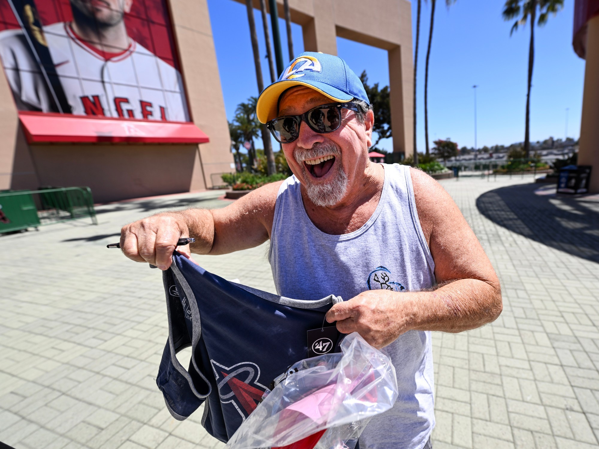 Angels fans celebrate online and in person after Stan Kroenke agrees to purchase team.