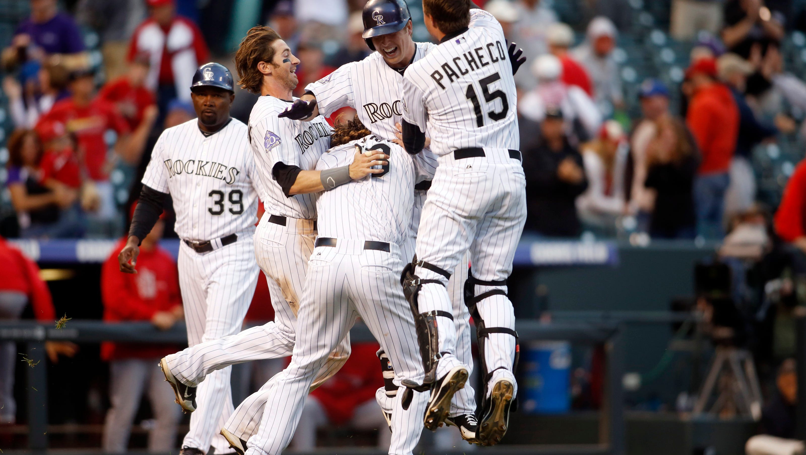 Colorado Rockies defeat St. Louis Cardinals 10-7 during National League wild-card chase.