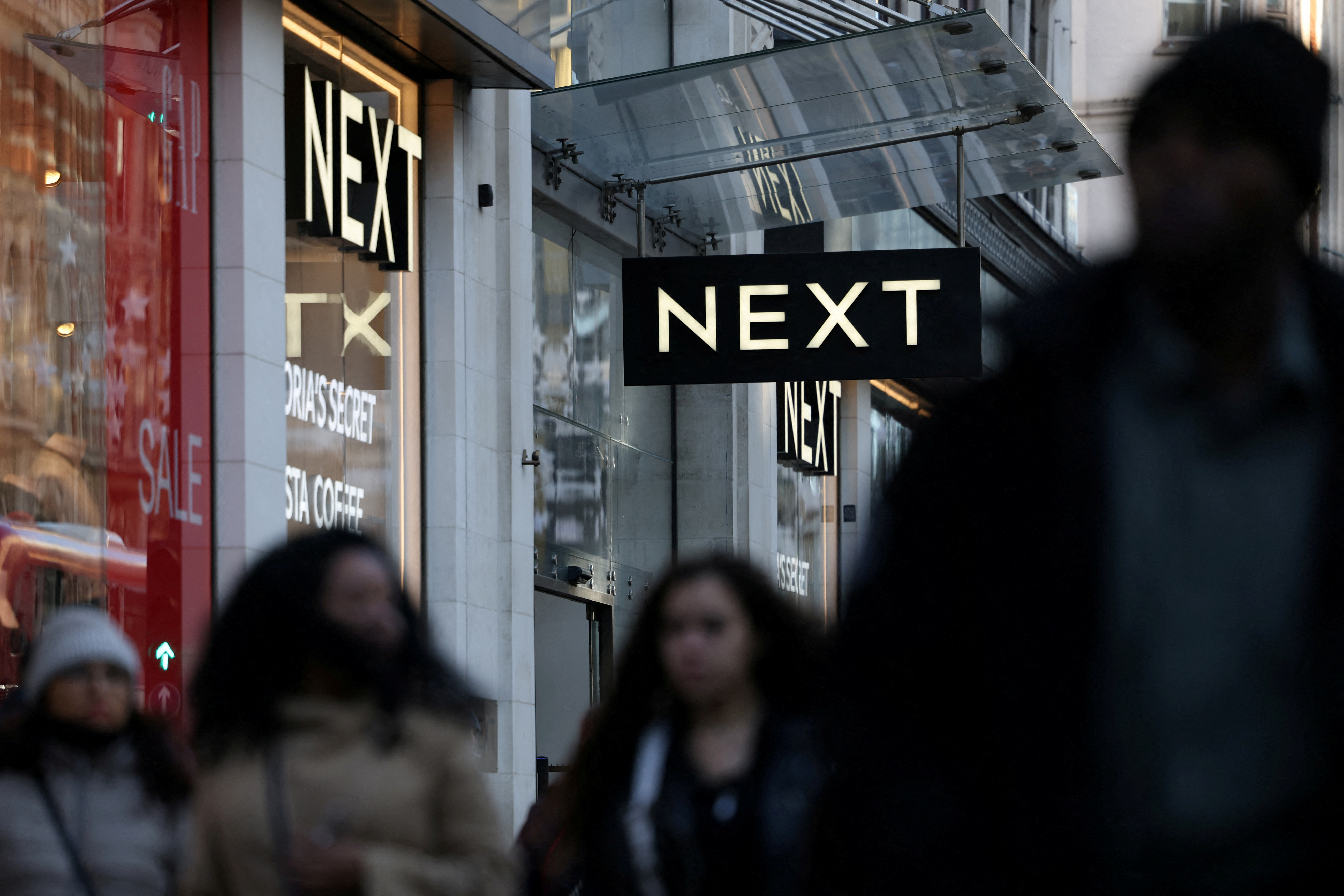 British retailer Next raises full-year profit guidance despite expecting slower domestic sales growth.