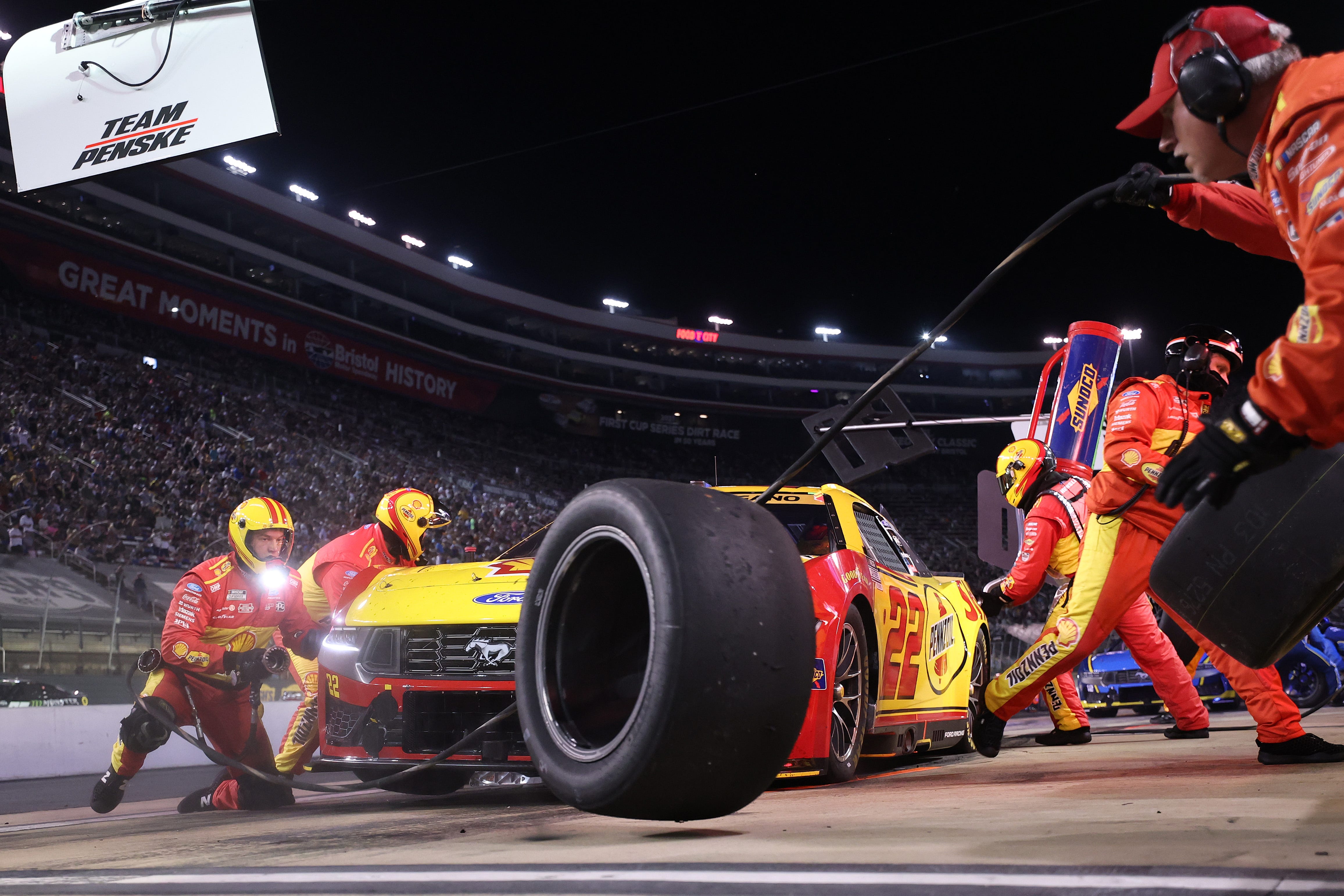 Joey Logano secures victory at Bristol after a chaotic late restart in NASCAR playoffs.