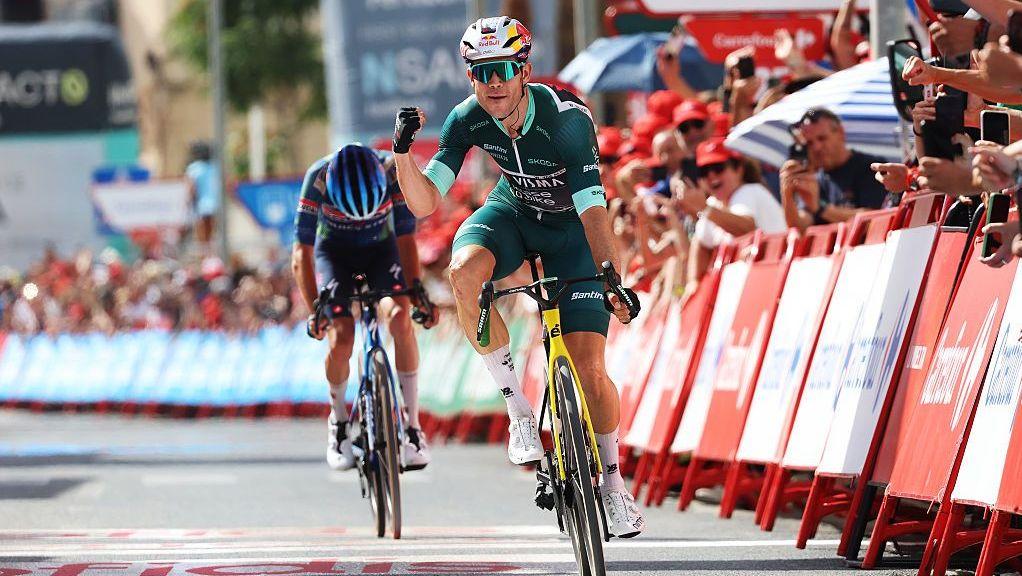 Wout van Aert secures his first Vuelta stage win amidst punishing heat.