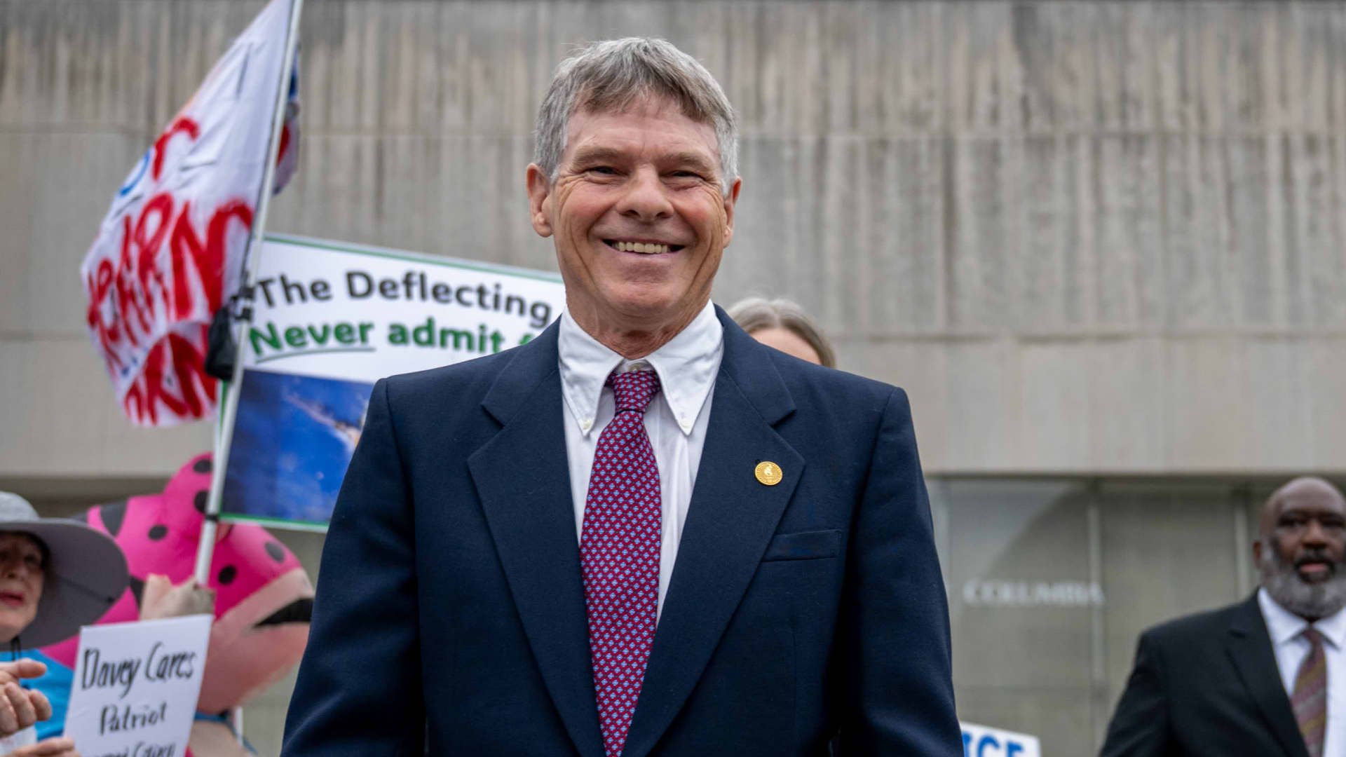 Judge dismisses case against former Olympian David Hearn, barring DOJ from refiling charges.