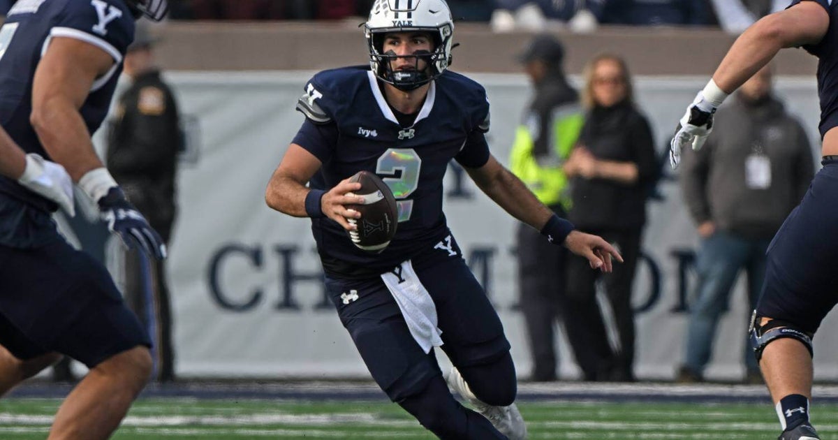 Yale quarterback Dante Reno throws four touchdowns in victorious first game since his father's death.