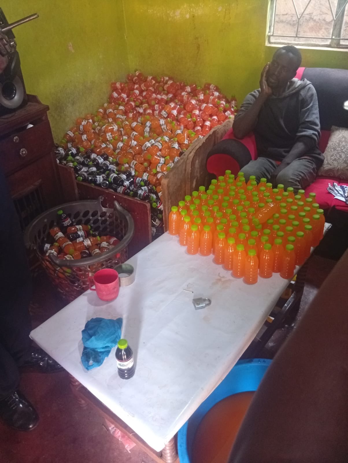 Two suspects arrested as police raid illegal counterfeit juice packaging operation in Kabete.