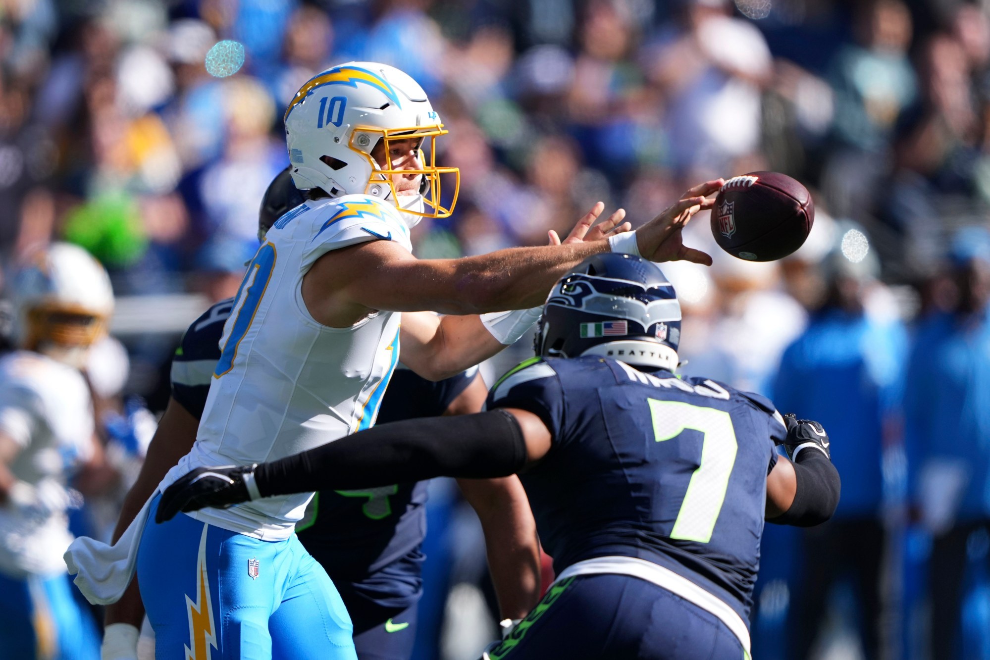 Seahawks hold off late Chargers rally to secure a penalty-filled 30-23 victory.
